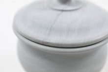 Load image into Gallery viewer, Handcrafted grey stone pet ashes casket close up.
