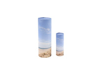 Load image into Gallery viewer, Large and small cylindrical pet ashes scattering tubes with a beach scene image.
