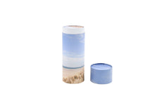 Load image into Gallery viewer, Cylindrical pet ashes scattering tube with a beach scene image, with lid off.
