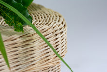 Load image into Gallery viewer, Handwoven rattan pet coffin corner close up.
