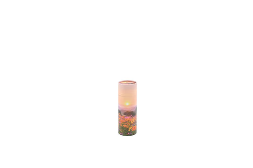 Small cylindrical pet ashes scattering tube with a flower meadow image.